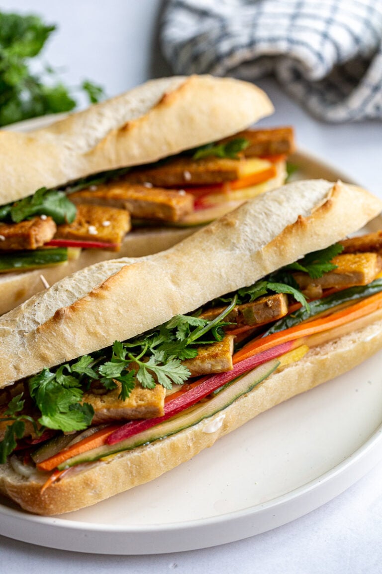 Tofu Banh Mi sandwich on a white plate.