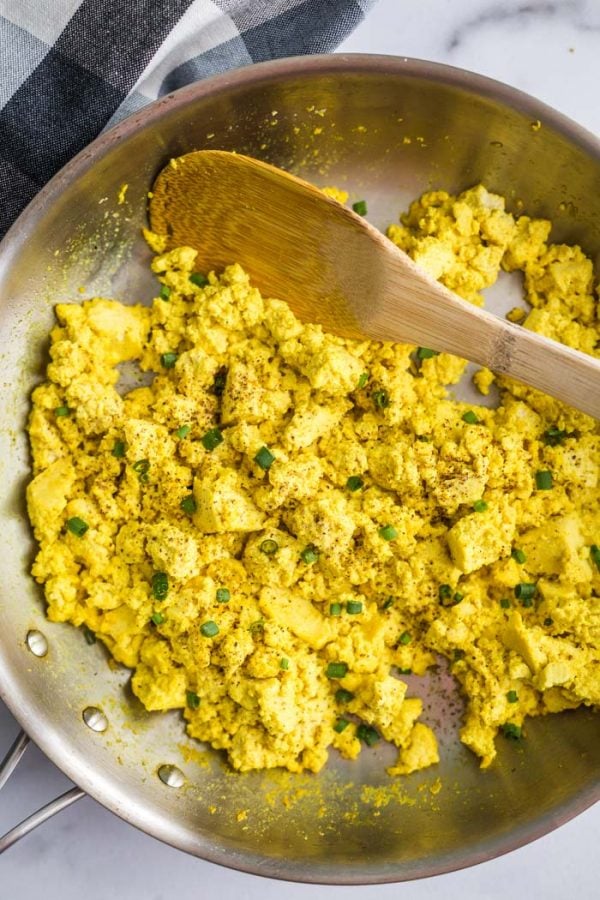 top down shot of tofu scramble in a skillet topped with chives and pepepr