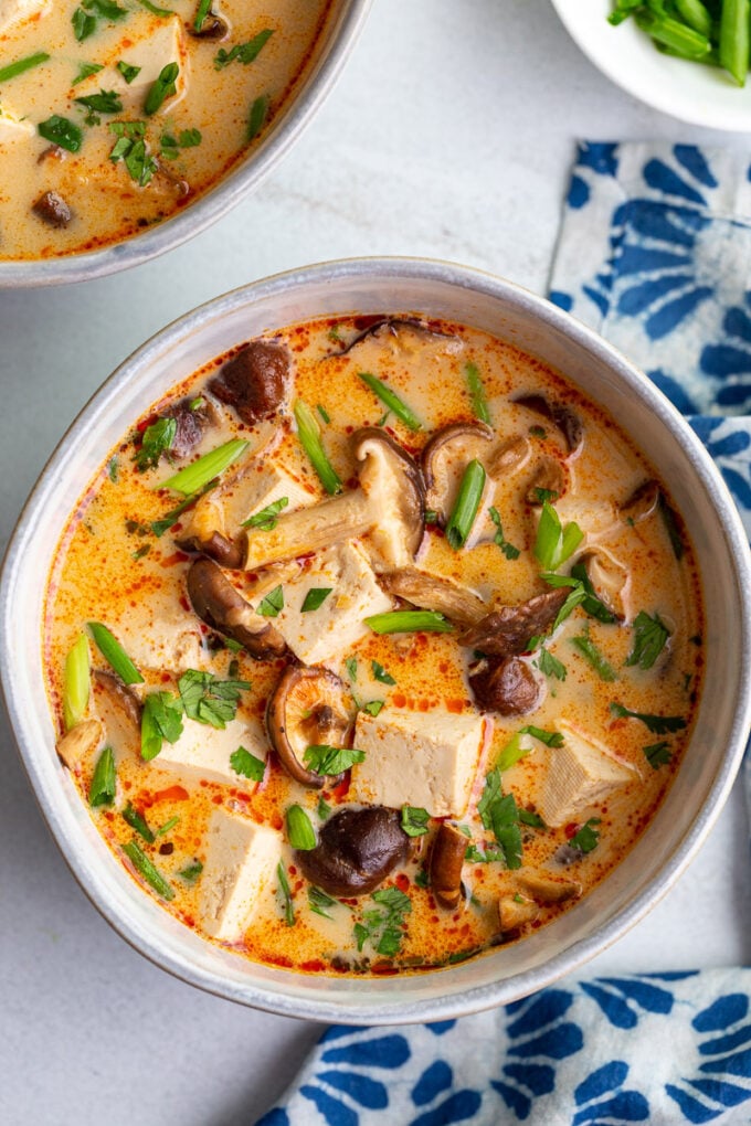 Soup made with tofu and black beans in a white bowl.