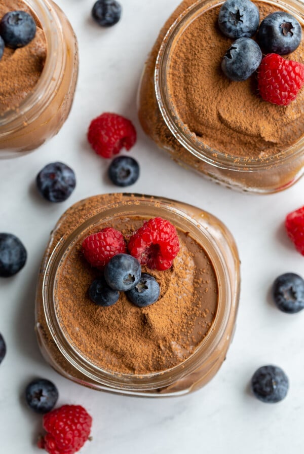 vegan chocolate mousse in a small jar with berries