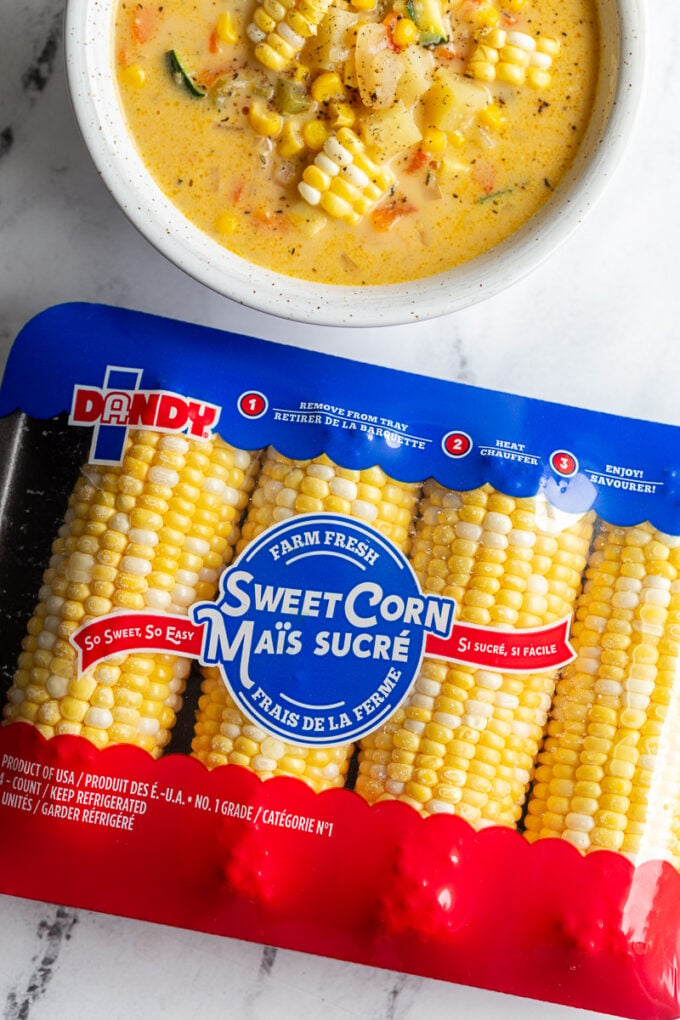 Package of Dandy Sweet Corn with a bowl of corn chowder in the corner