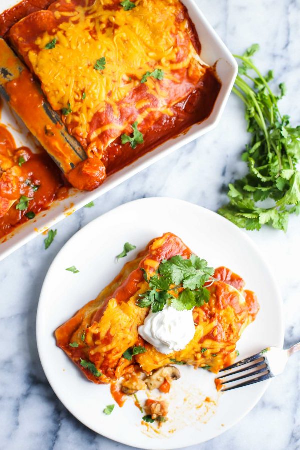 enchiladas on a plate with a bit taken out