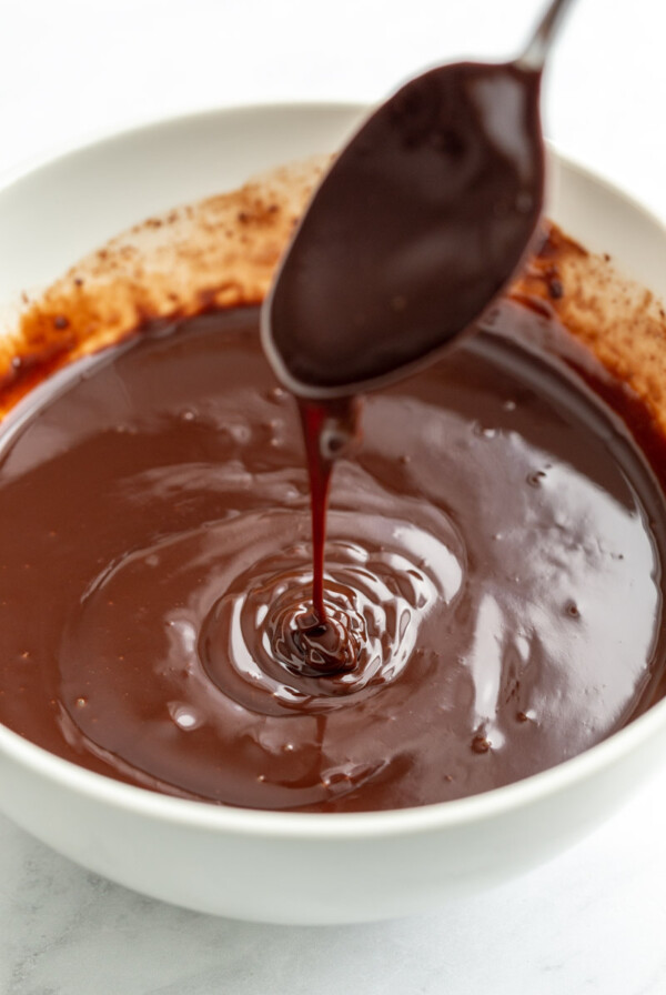 Vegan Chocolate Ganache dripping from a spoon