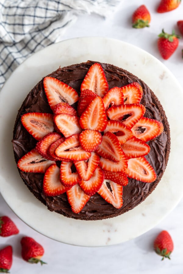 Chocolate cake topped with sliced strawberries.