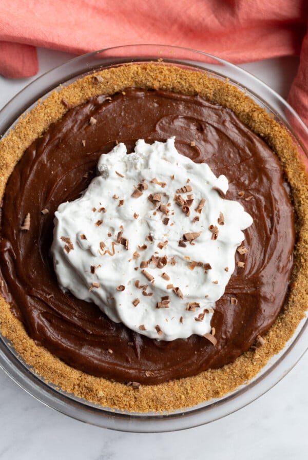 Chocolate Peanut Butter Pie topped with coconut whipped cream.