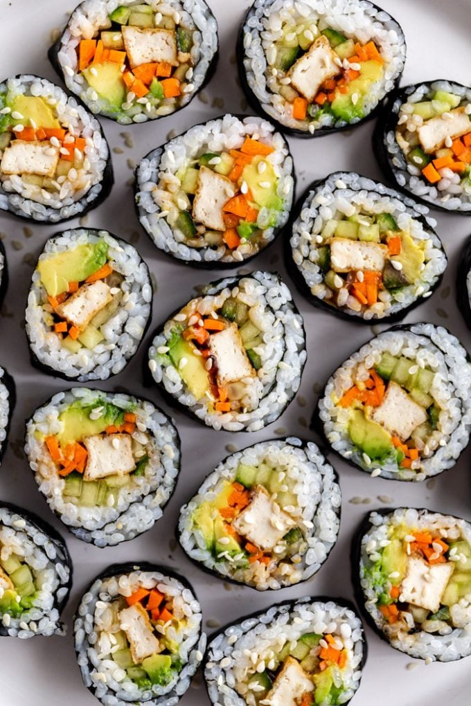 top down shot of a plate of tofu sushi filled with tofu, carrots, avocado, and cucumber