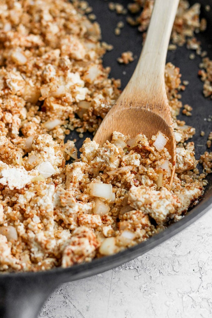 skillet with tofu and quinoa taco "meat" in it. spoon hanging out the side