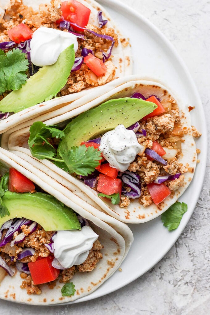 3 tortillas filled with vegan taco meat and fresh veggies