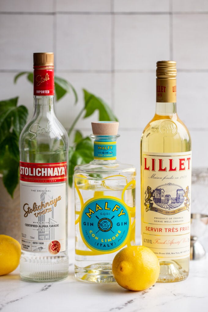 vesper martini ingredients: vodka bottle, gin bottle, and lillet bottle