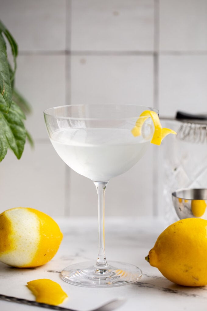 vesper cocktail in a cocktail glass with a lemon twist on the side