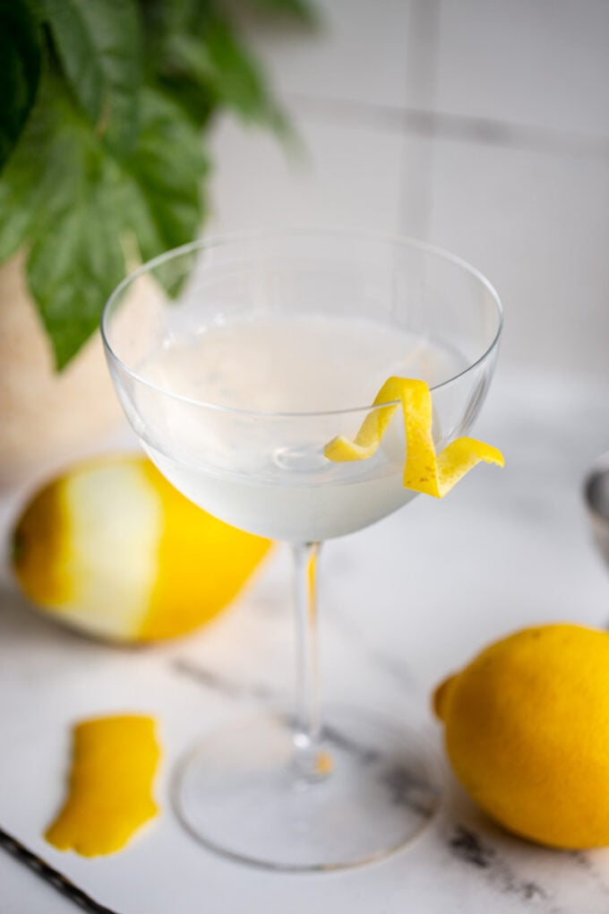 vesper cocktail in a cocktail glass with a lemon twist on the side