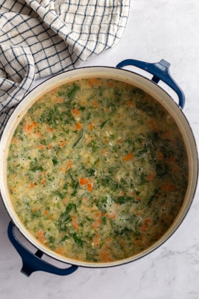 cooking white bean soup in a large pot