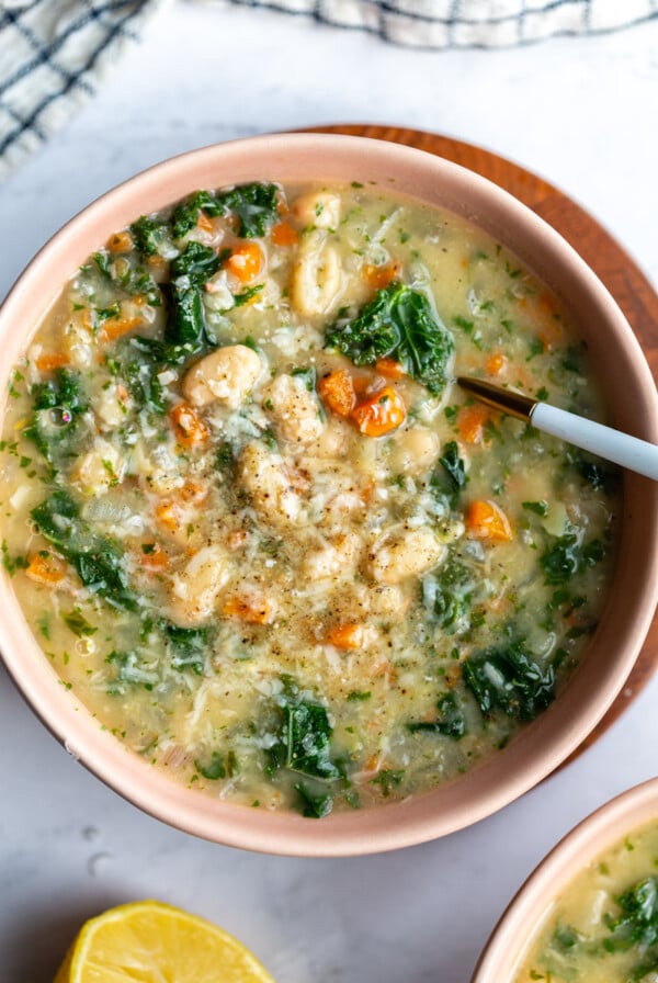 white bean and kale soup in a bowl with a spoon