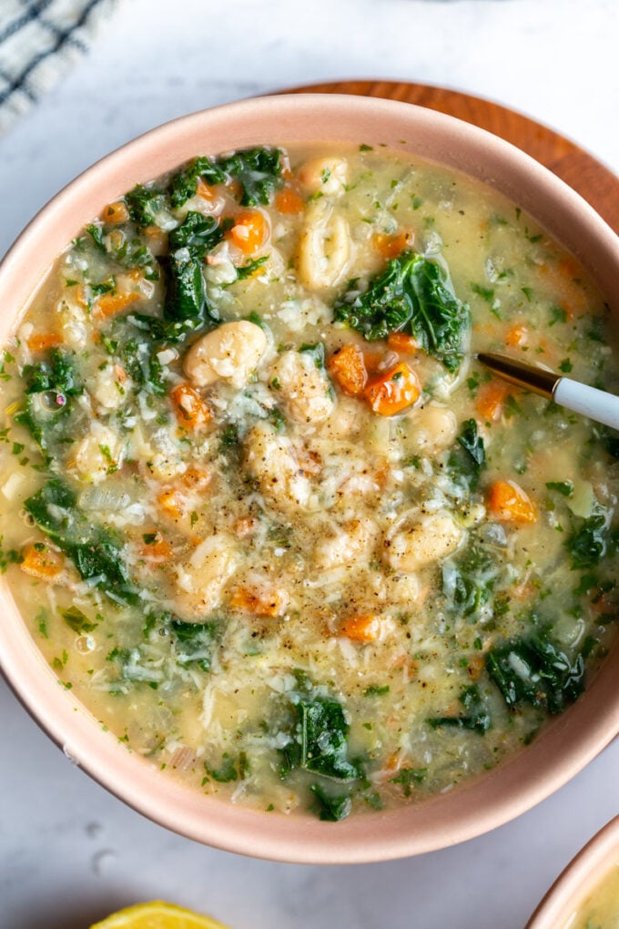 white bean kale soup served in a bowl with a spoon